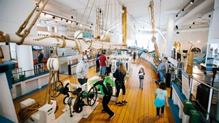 Photo of families on board the model ship housed within Discovery World